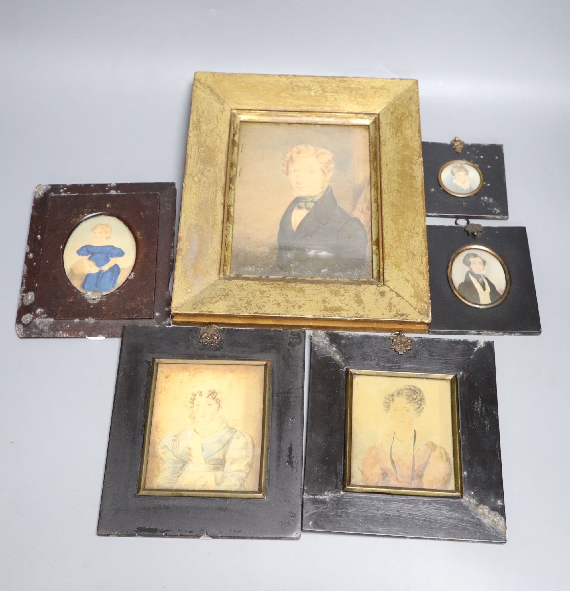 Six portrait miniatures, first half 19th century, some on ivory including a primitive example of a girl and a dog